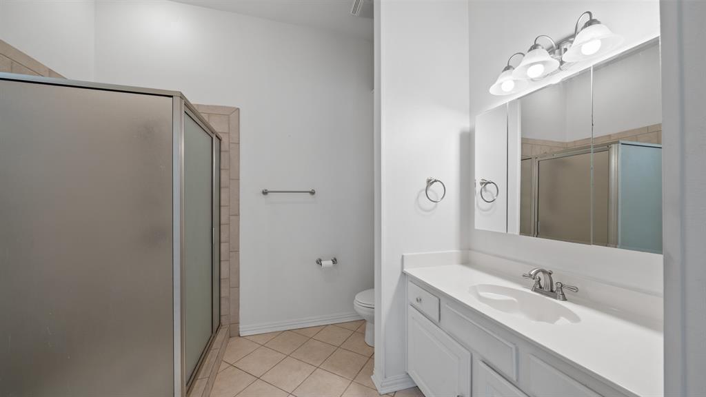 875 Arnold Paul Road Canton, TX 75103 - Photo 23 of 32 a bathroom with a double vanity sink mirror and toilet