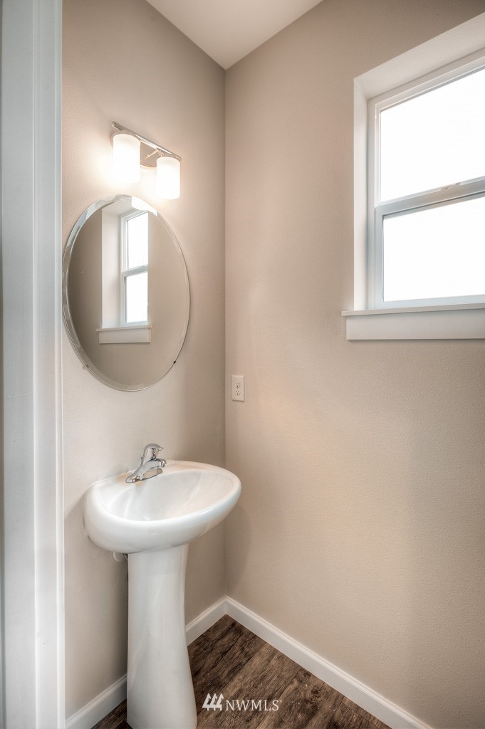 21126 Meridian Drive Southeast, Unit P2 Bothell, WA 98021 - Photo 23 of 29 a bathroom with a sink a mirror and a toilet