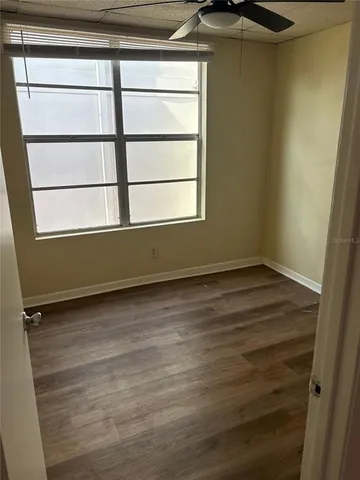 a view of a room with wooden floor and window