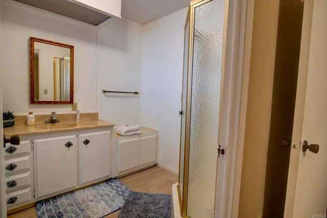 a spacious bathroom with a double vanity sink and mirror