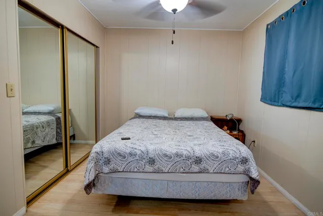 a bedroom with a bed and wooden floor
