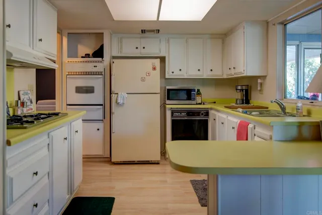 a kitchen with a sink a stove and refrigerator