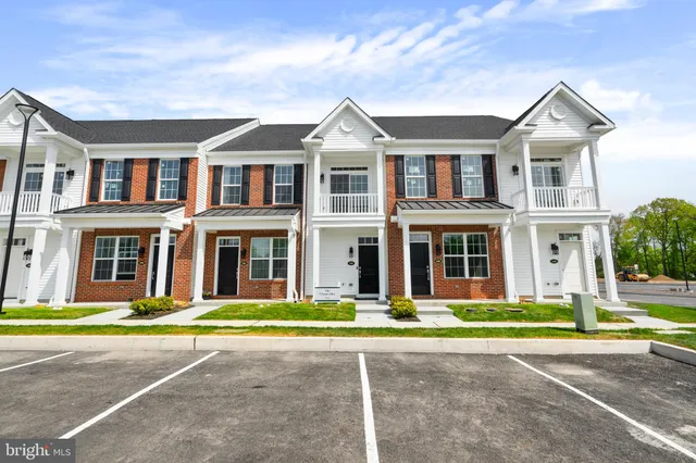 a front view of a brick house with a yard