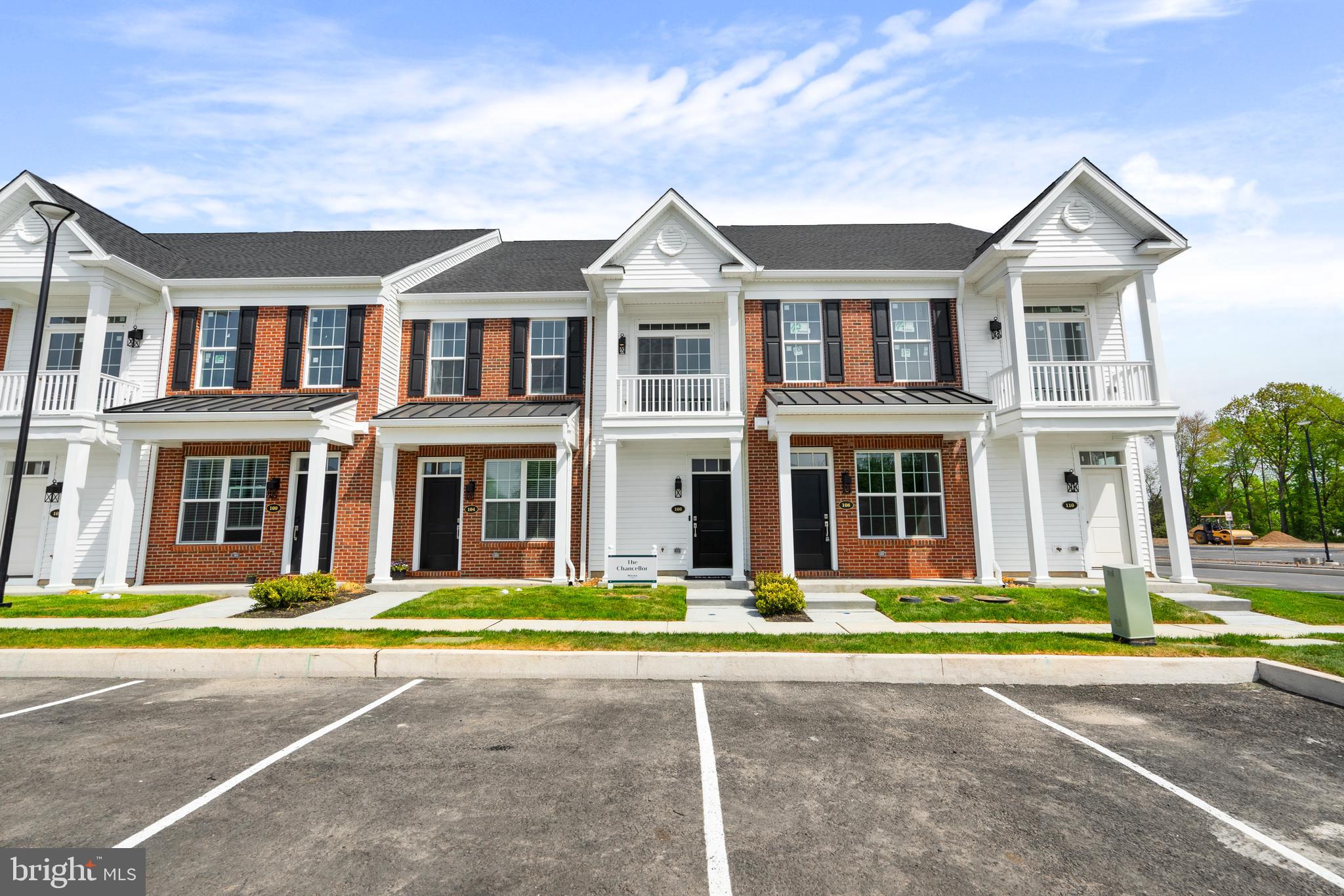 a front view of a brick house with a yard
