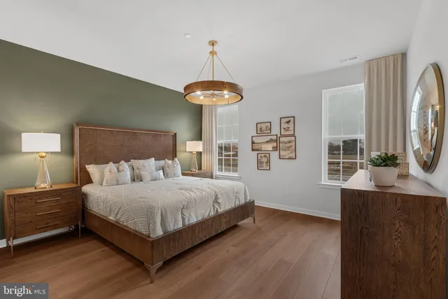 a bedroom with a bed a mirror and a window