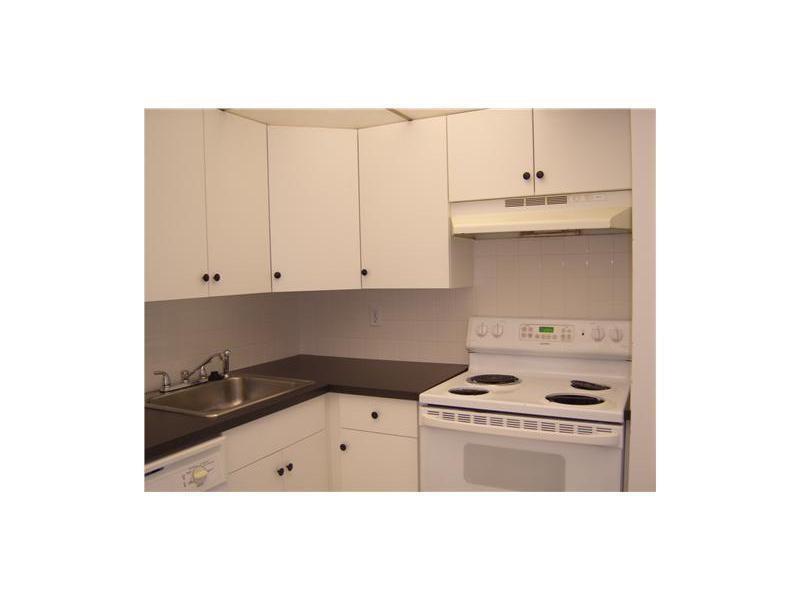 4158 Inverrary Drive, Unit 404 Lauderhill, FL 33319 - Photo 2 of 15 a kitchen with cabinets and appliances