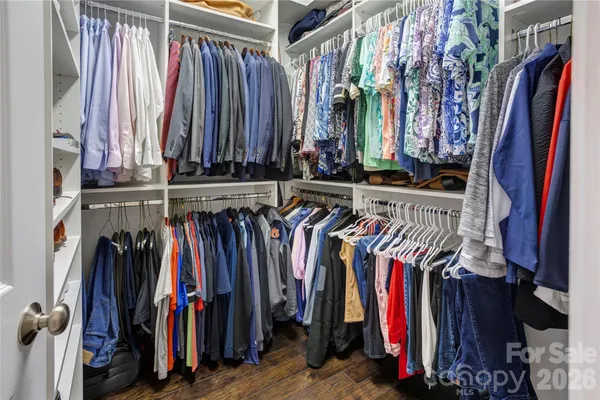 a view of walk in closet with clothes