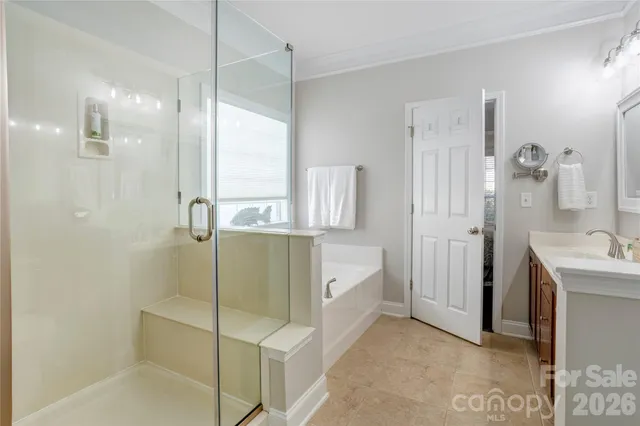 a bathroom with a double vanity sink and shower