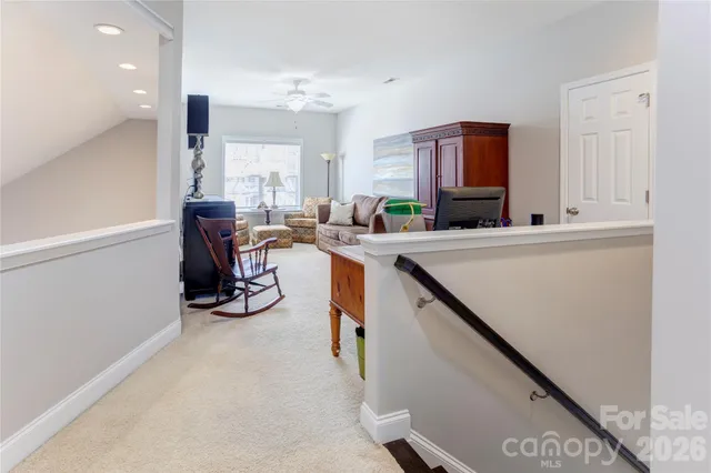 a view of a kitchen with kitchen island a sink wooden floor and a large window