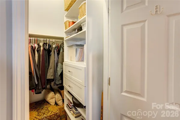 a view of walk in closet with clothes