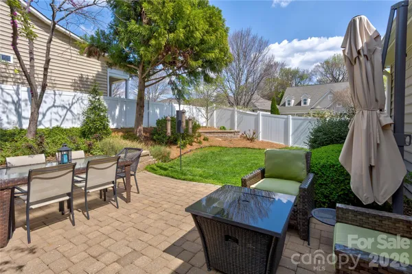 a view of a patio with a dining table and chairs with a fire pit and a chairs
