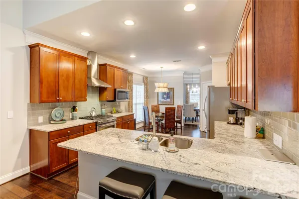a kitchen with granite countertop a sink and cabinets