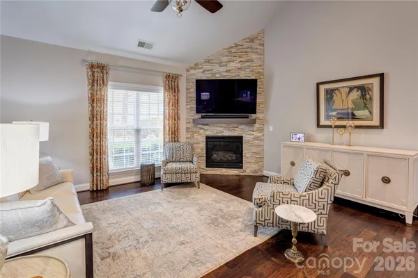 a living room with furniture and a fireplace