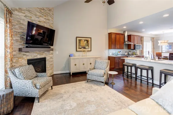a living room with fireplace furniture and a flat screen tv
