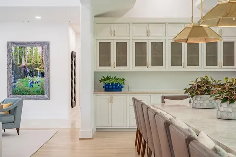 a dining room with furniture and wooden floor