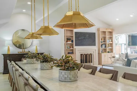 a large kitchen with stainless steel appliances granite countertop a lot of counter space and wooden floor