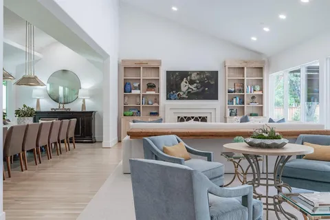 a room with kitchen island a sink a stove and a window