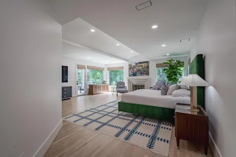 a spacious bedroom with a bed and a large window