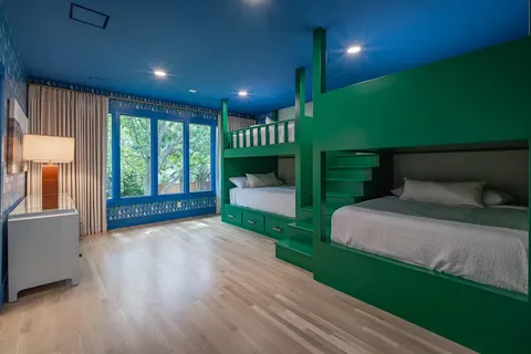 a bedroom with a large bed couch and a window