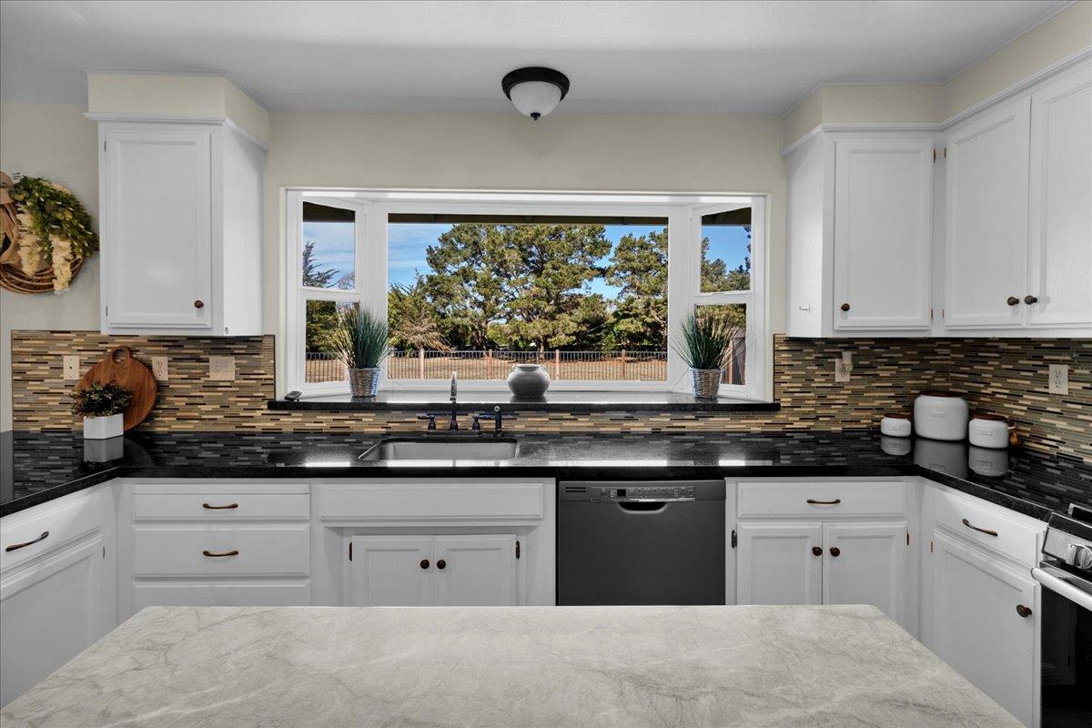 18595 Ranchito Del Rio Drive Salinas, CA 93908 - Photo 14 of 40 a kitchen with white cabinets and a window
