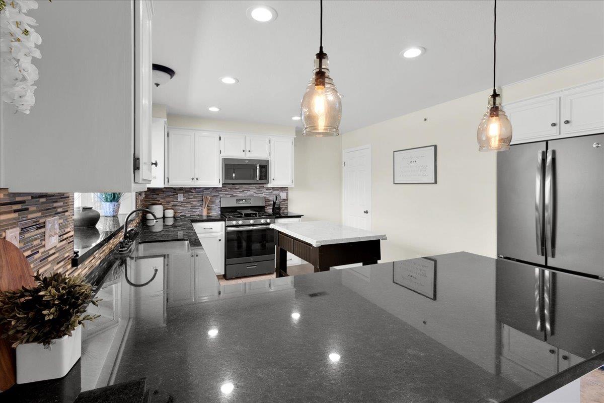 18595 Ranchito Del Rio Drive Salinas, CA 93908 - Photo 15 of 40 a kitchen with stainless steel appliances a refrigerator sink and stove