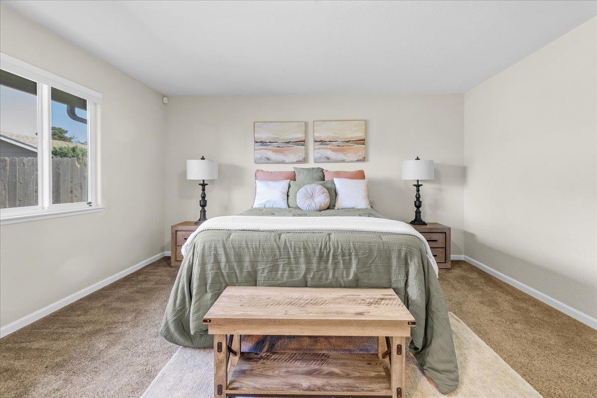 18595 Ranchito Del Rio Drive Salinas, CA 93908 - Photo 18 of 40 a bedroom with a bed a table and chair