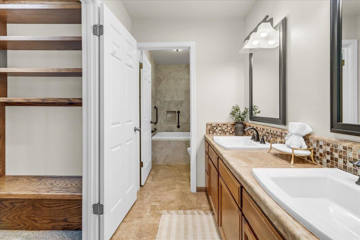18595 Ranchito Del Rio Drive Salinas, CA 93908 - Photo 19 of 40 a bathroom with a double vanity sink and mirror with shower