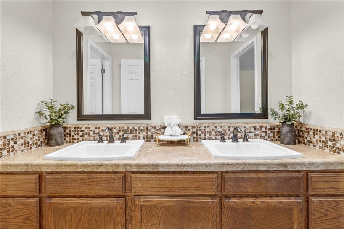 18595 Ranchito Del Rio Drive Salinas, CA 93908 - Photo 20 of 40 a bathroom with double vanity sinks and a mirror
