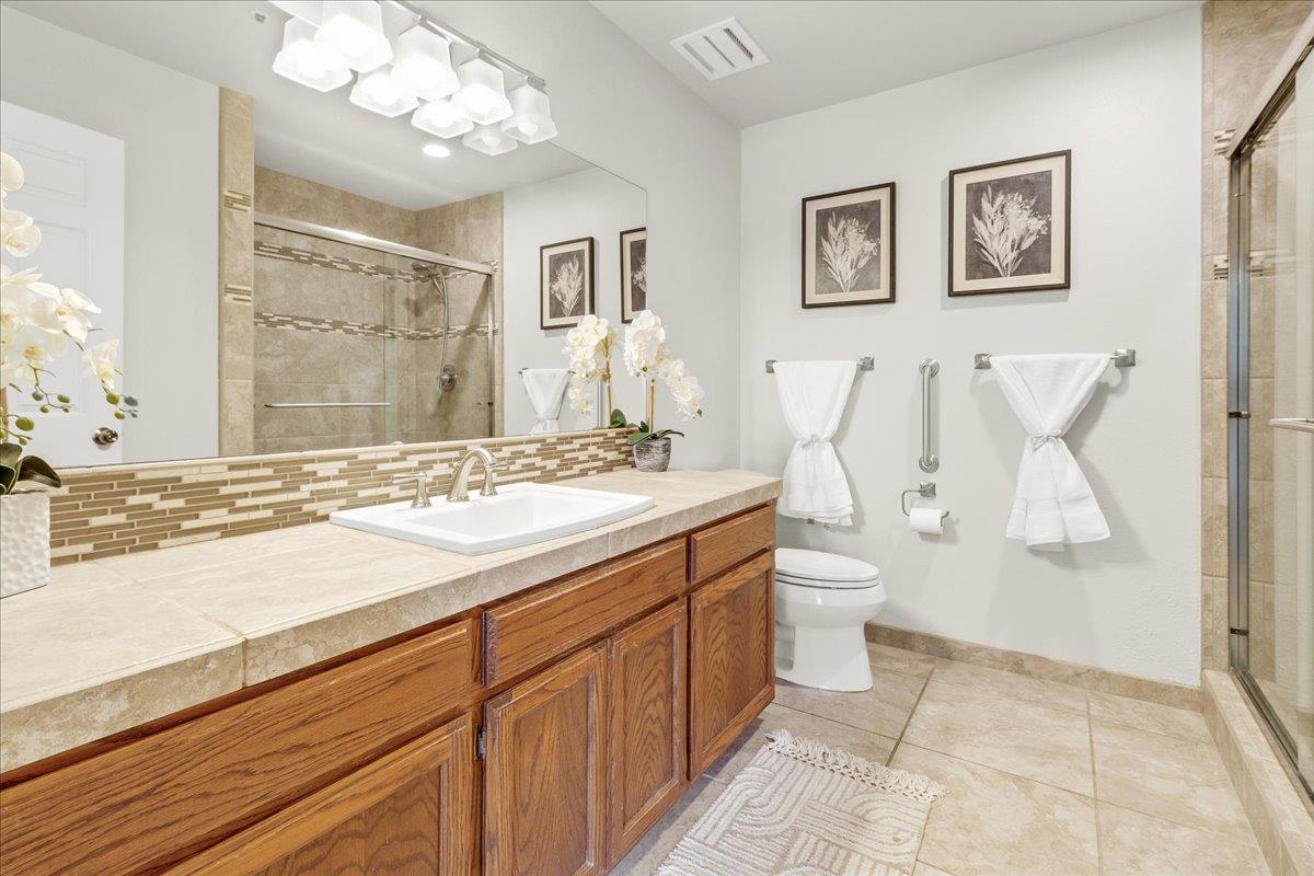 18595 Ranchito Del Rio Drive Salinas, CA 93908 - Photo 21 of 40 a bathroom with a granite countertop sink mirror and a