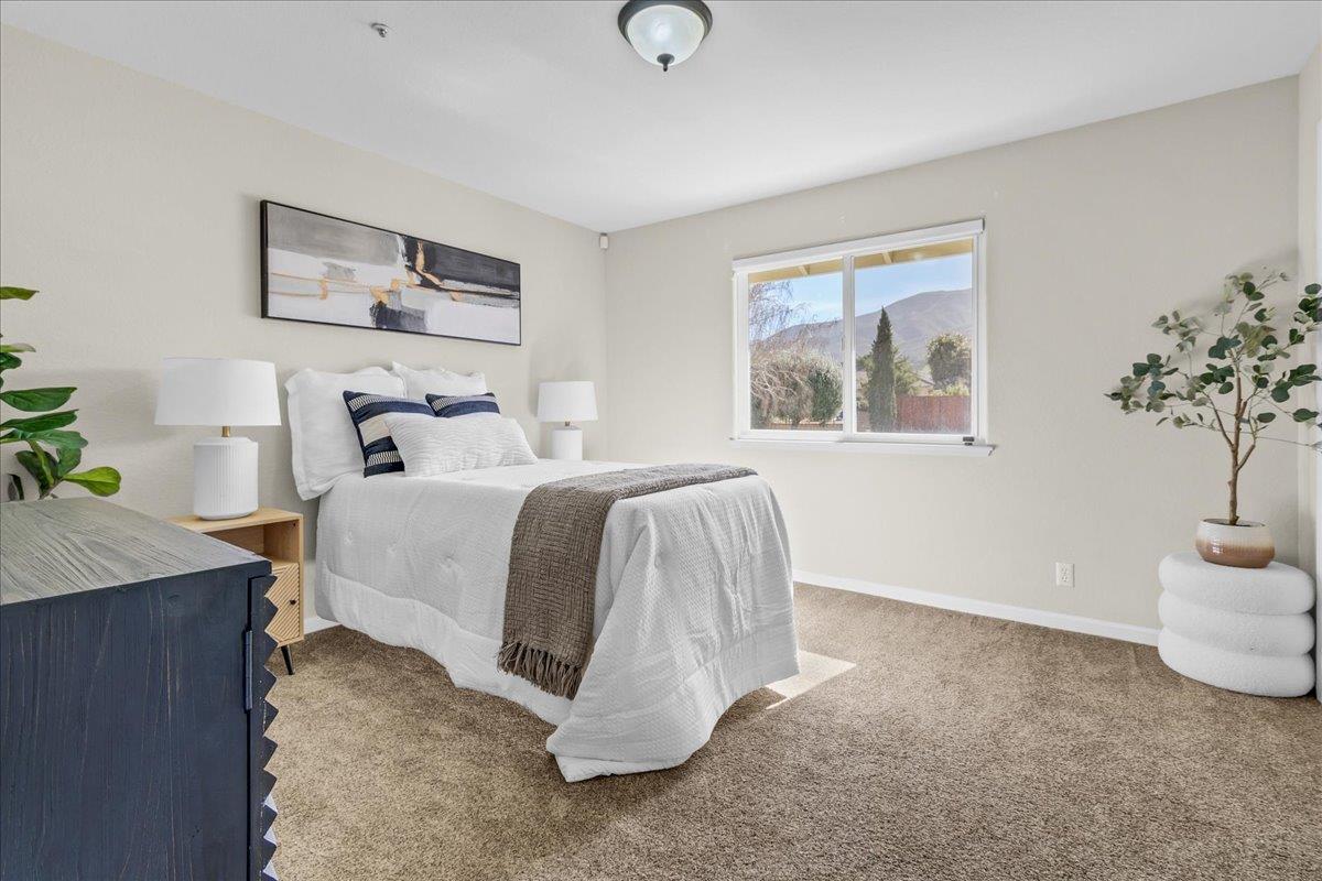 18595 Ranchito Del Rio Drive Salinas, CA 93908 - Photo 23 of 40 a bedroom with a bed and a table
