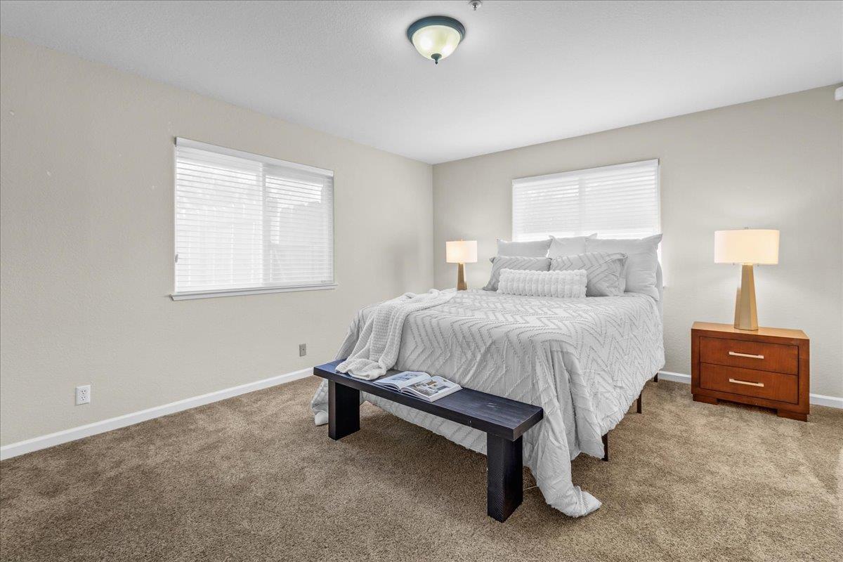 18595 Ranchito Del Rio Drive Salinas, CA 93908 - Photo 27 of 40 a spacious bedroom with a bed and a lamp