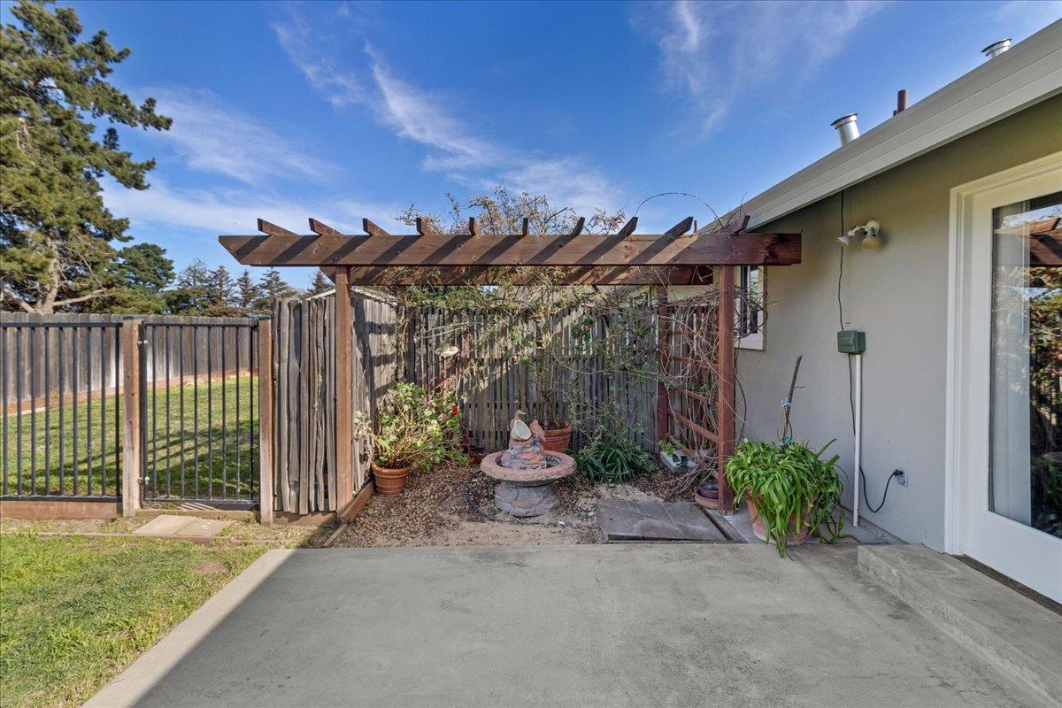 18595 Ranchito Del Rio Drive Salinas, CA 93908 - Photo 31 of 40 a backyard of a house with table and chairs potted plants with wooden fence