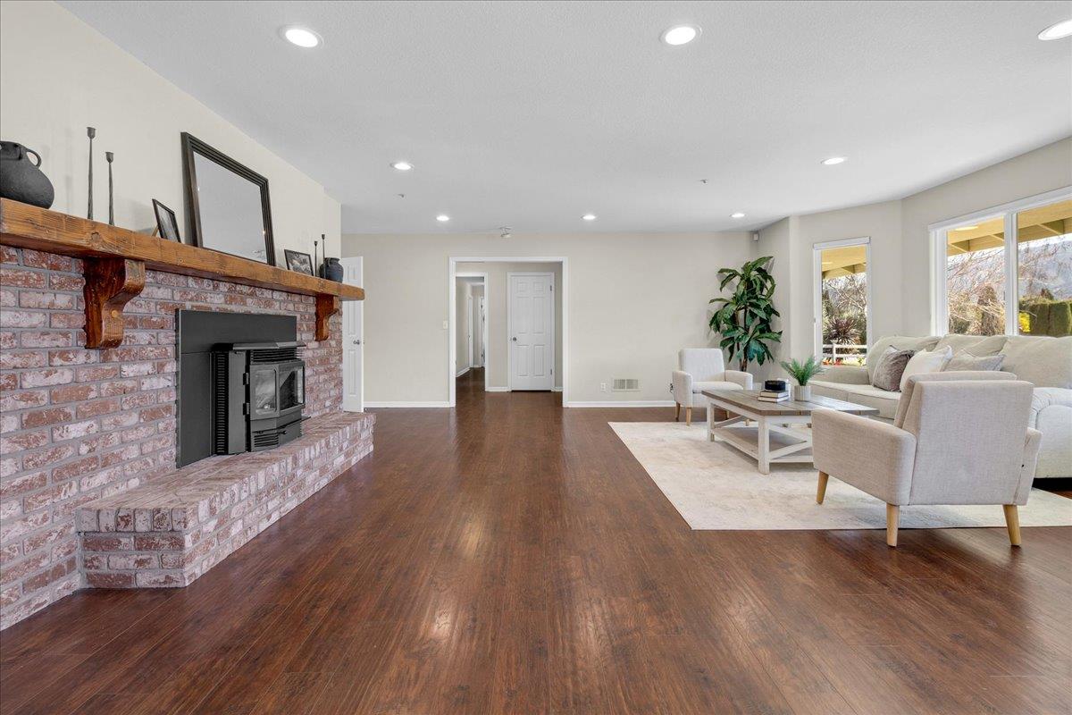 18595 Ranchito Del Rio Drive Salinas, CA 93908 - Photo 8 of 40 a living room with furniture a fireplace and wooden floor