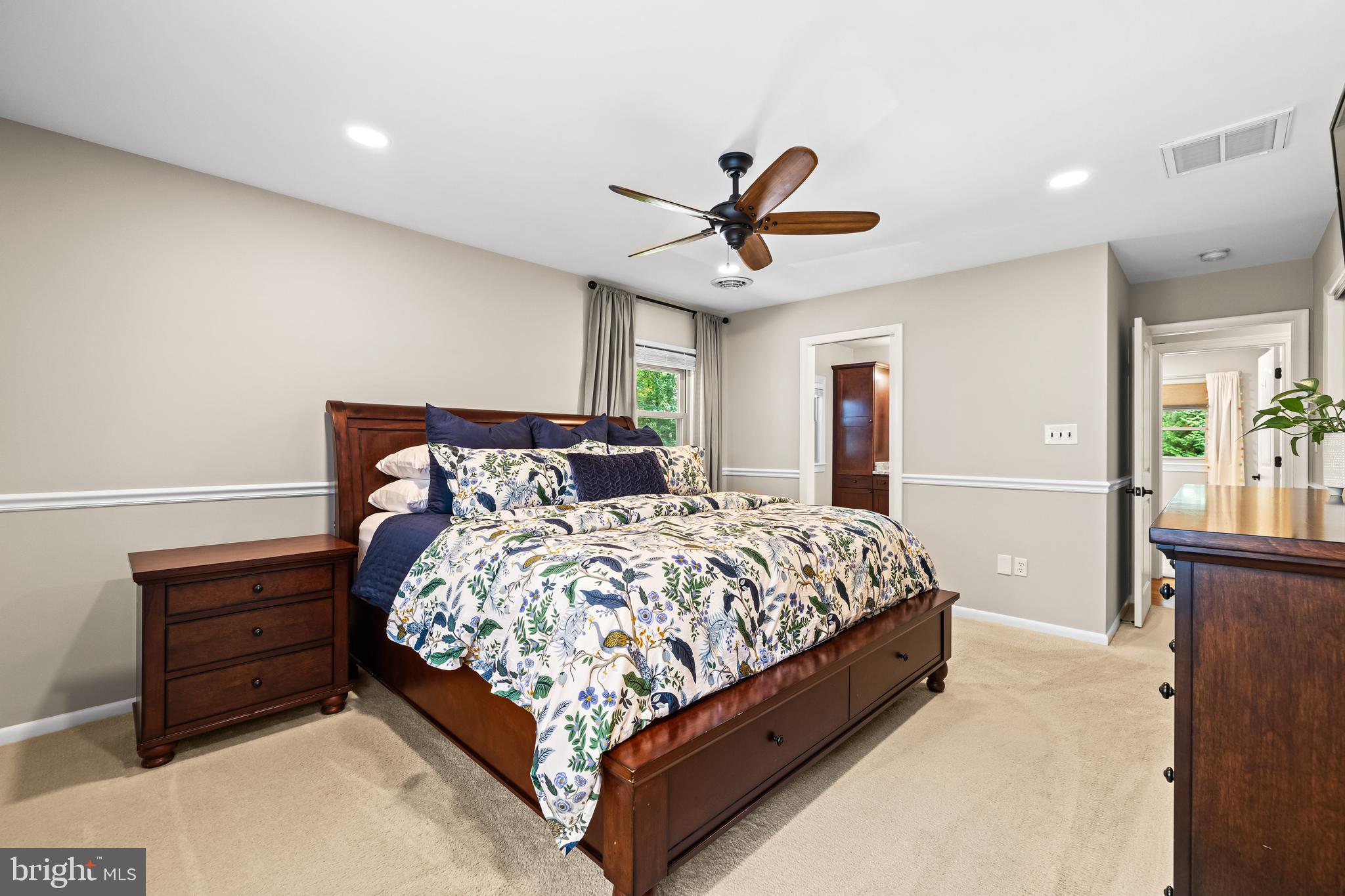 5507 Williams Road Hydes, MD 21082 - Photo 17 of 39 a bed sitting in a spacious bedroom next to a window and a chandelier