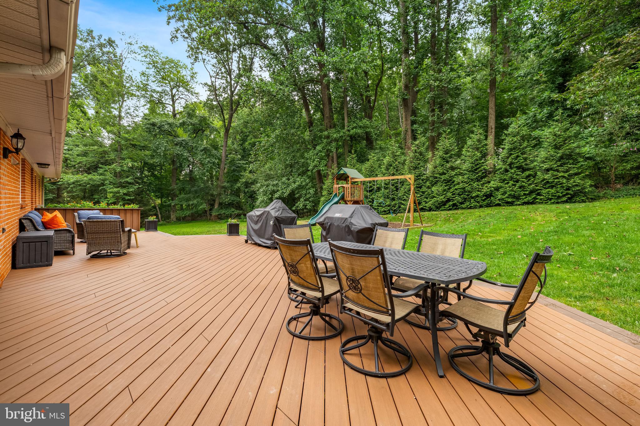 5507 Williams Road Hydes, MD 21082 - Photo 32 of 39 a view of a patio with table and chairs and couches with wooden floor and fence