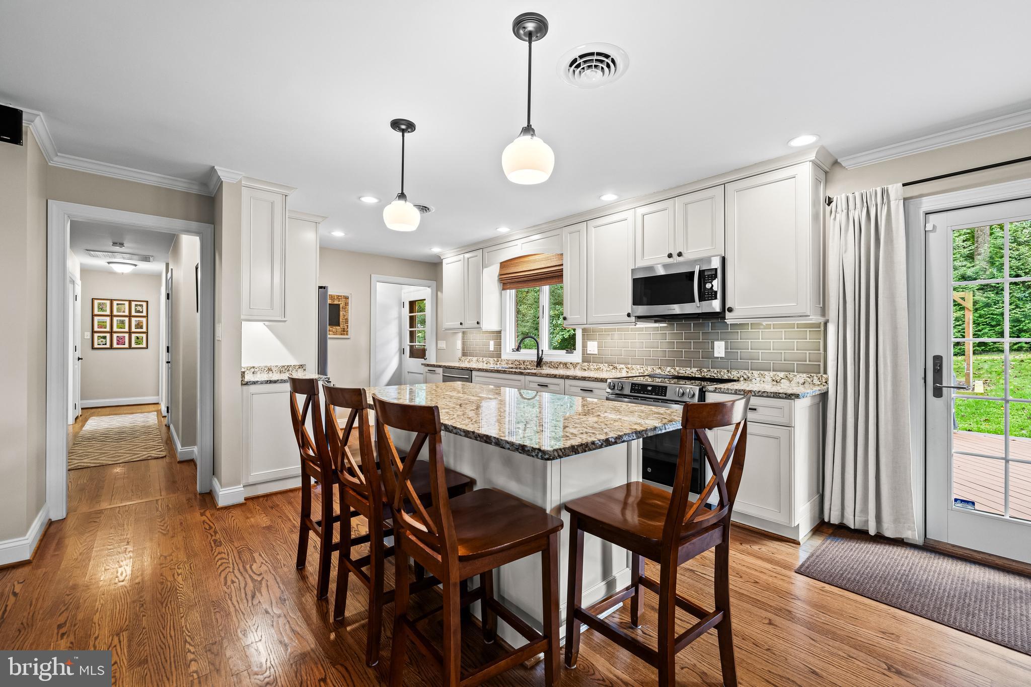 5507 Williams Road Hydes, MD 21082 - Photo 7 of 39 a view of a dining room and livingroom with furniture wooden floor a chandelier