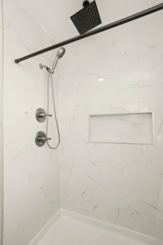 a bathroom with a shower and a shower head