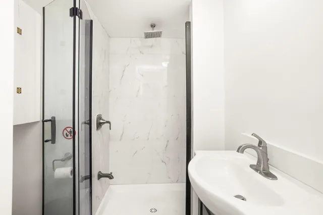 a bathroom with a shower and a sink