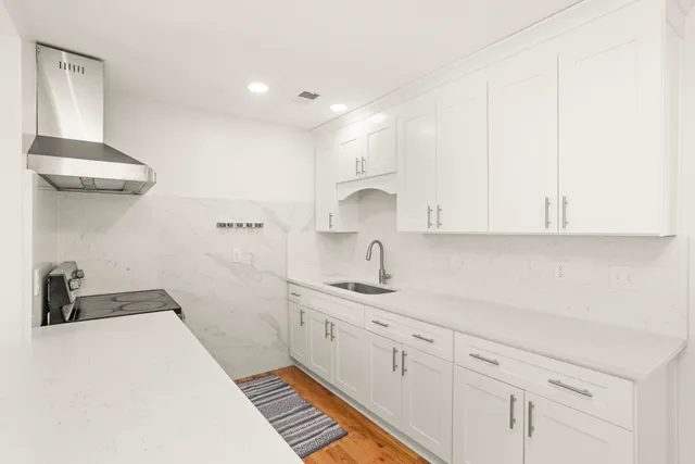 a kitchen with a sink and cabinets
