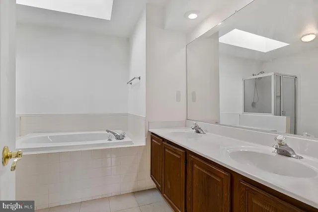 a bathroom with a bathtub a sink and a mirror
