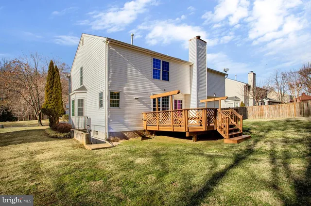 a backyard of a house with barbeque oven and outdoor seating