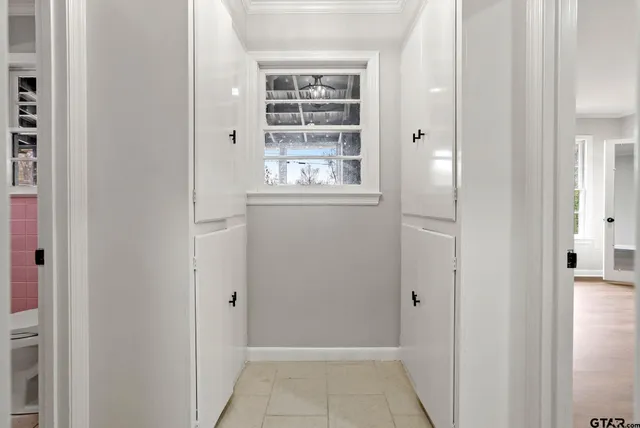 a view of a small space with wooden floor and a window