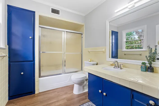 a bathroom with a granite countertop sink toilet and shower