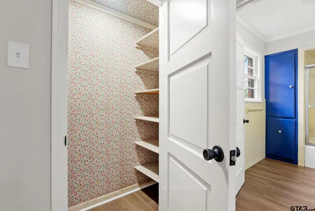 a view of a walk in closet and bathroom
