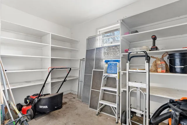 a view of storage and utility room with racks on the wall