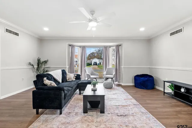 a living room with furniture and a floor to ceiling window