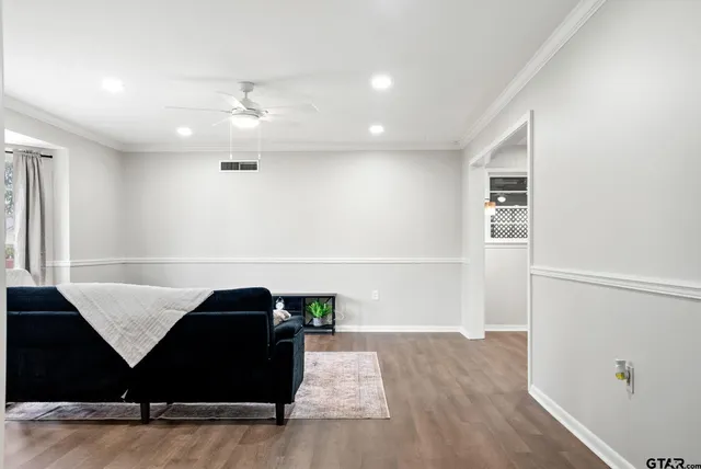 a living room with furniture and wooden floor