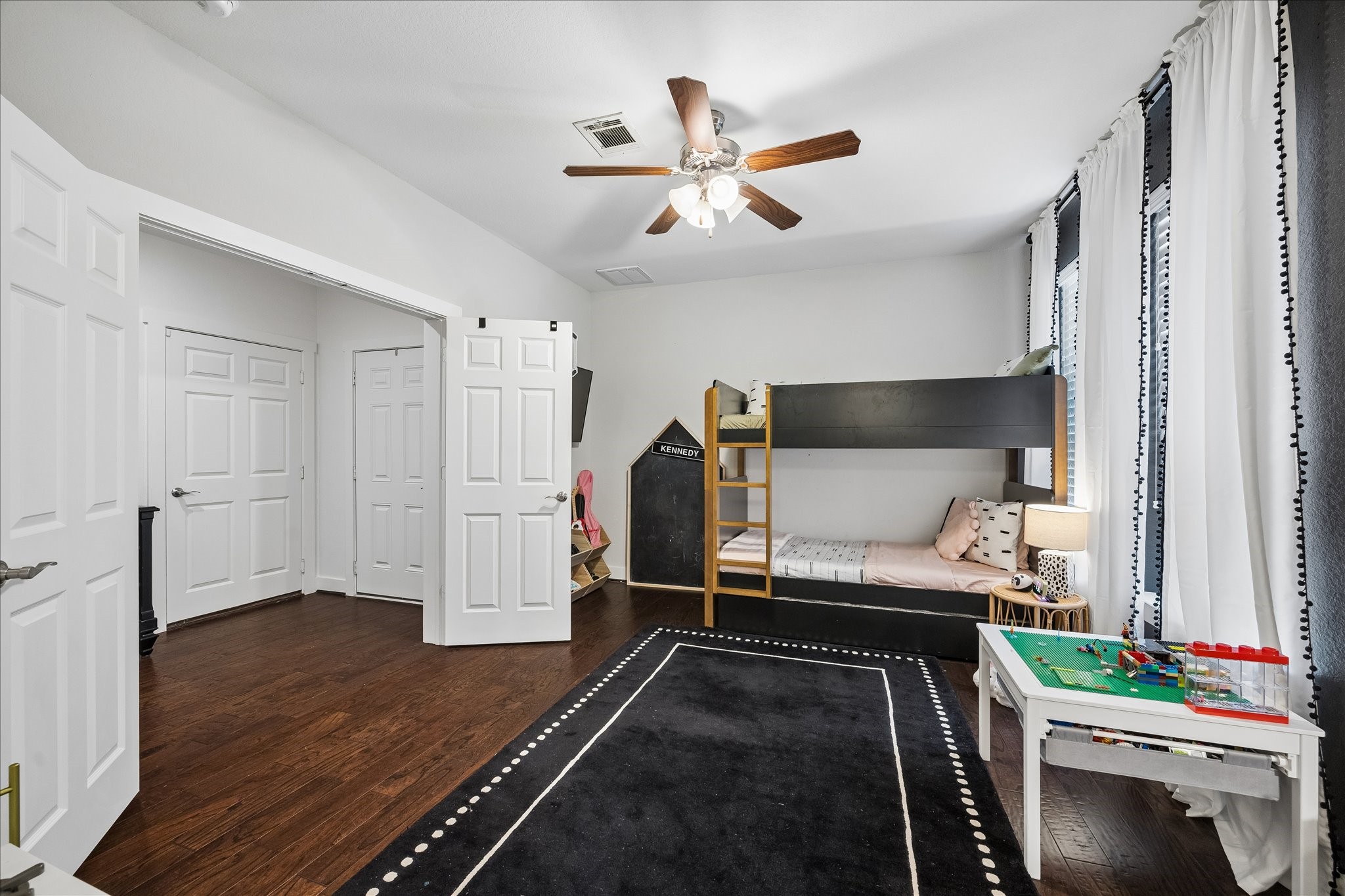 2416 Couch Street Houston, TX 77008 - Photo 12 of 34 a bedroom with a bed and a ceiling fan