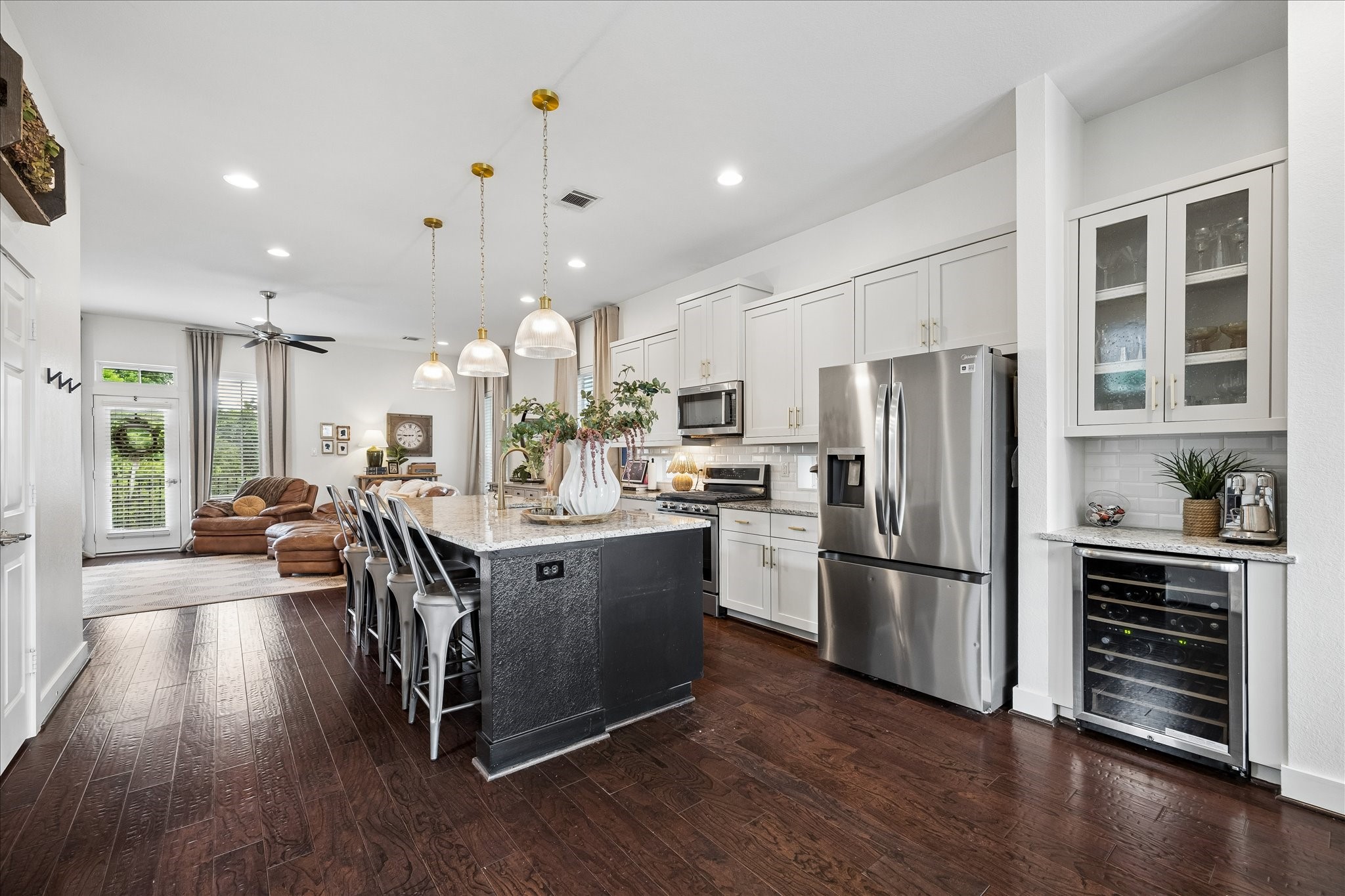 2416 Couch Street Houston, TX 77008 - Photo 18 of 34 a kitchen with kitchen island wooden floors appliances and cabinets