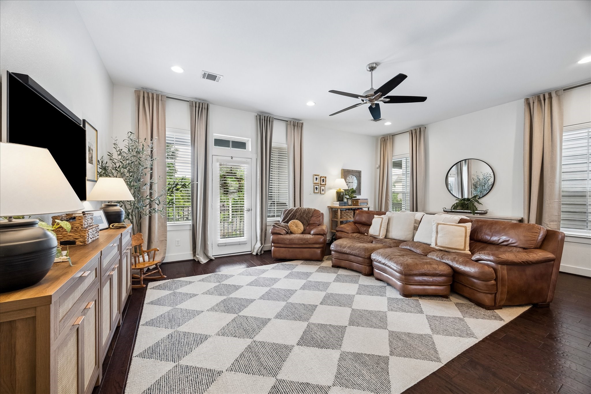 2416 Couch Street Houston, TX 77008 - Photo 2 of 34 a living room with furniture a flat screen tv and a large window